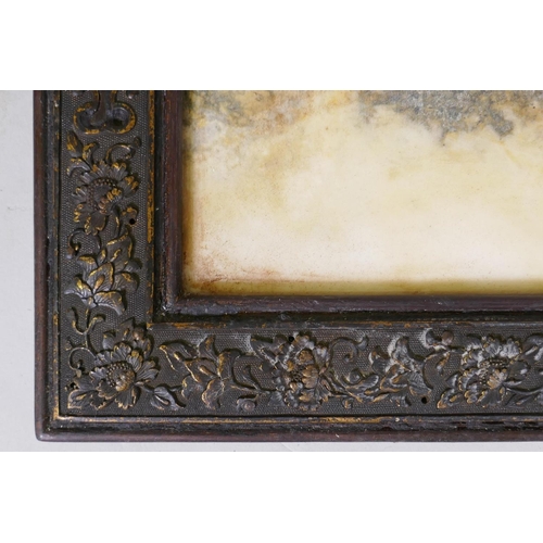 57 - A Chinese marble panel with moss green pattern, housed in a hardwood frame with finely cast metal mo... 