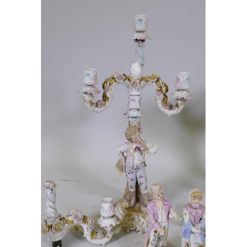 58 - A late C19th Volkstedt porcelain three branch candelabra in the form of a young man bearing a flower... 