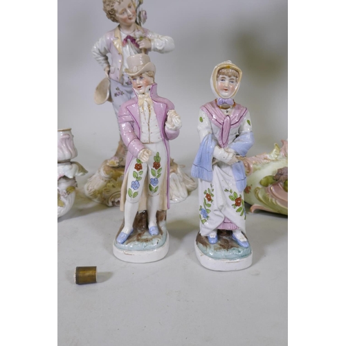 58 - A late C19th Volkstedt porcelain three branch candelabra in the form of a young man bearing a flower... 