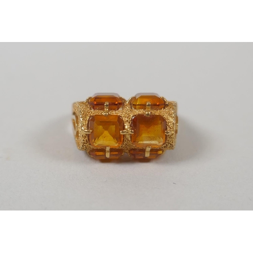 610 - An 18ct gold ring set with citrines, size O, 3.8g gross