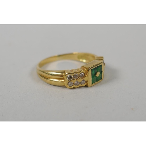 611 - An 18ct gold ring set with diamonds flanking emeralds, size M/N, 3.6g gross