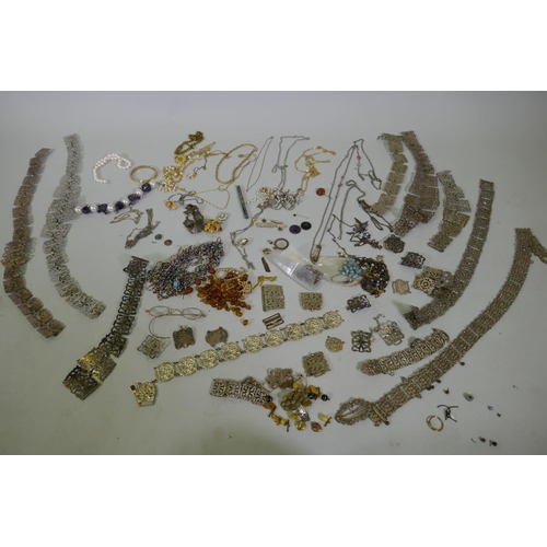 616 - A quantity of vintage costume jewellery including white metal belts and buckles