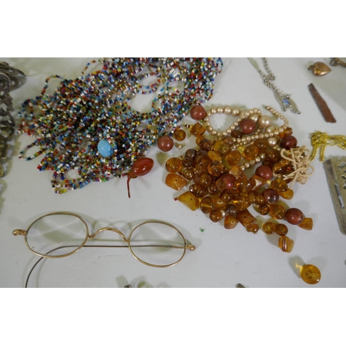 616 - A quantity of vintage costume jewellery including white metal belts and buckles