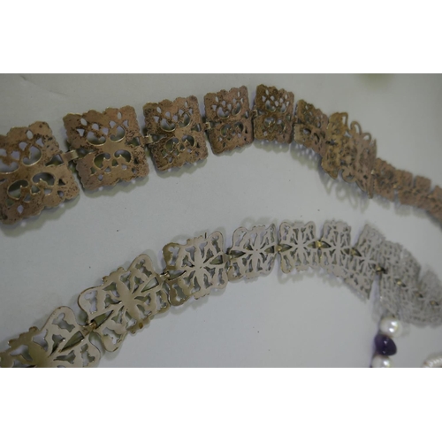 616 - A quantity of vintage costume jewellery including white metal belts and buckles