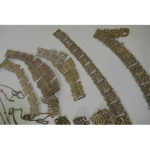 616 - A quantity of vintage costume jewellery including white metal belts and buckles