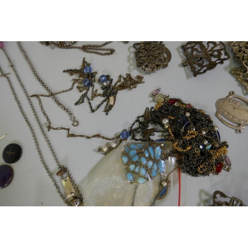 616 - A quantity of vintage costume jewellery including white metal belts and buckles