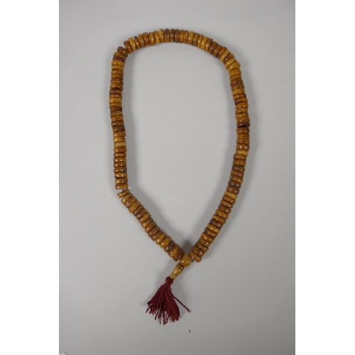 618 - A string of bone mala beads, 50cm long