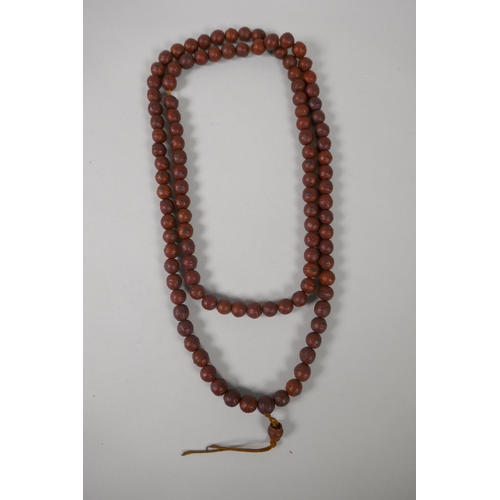 619 - A string of Rudraksha mala beads, 138cm long