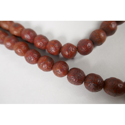 619 - A string of Rudraksha mala beads, 138cm long