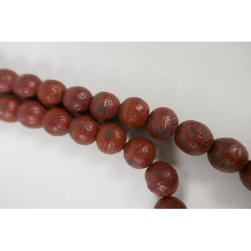 619 - A string of Rudraksha mala beads, 138cm long