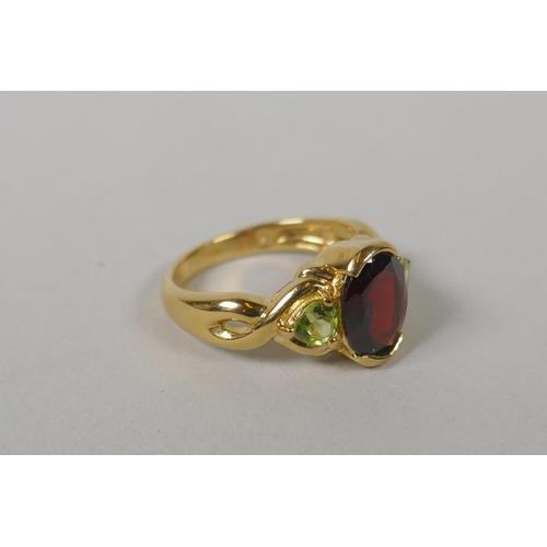 628 - A 14ct gold lady's dress ring set with a large marquise cut garnet encircled by ten smaller, size O,... 