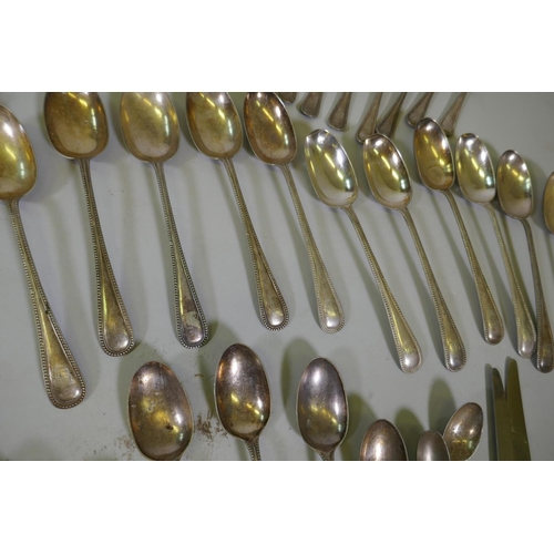 635 - A quantity of silver plated flatware, a set of twelve horn handled knives, a silver mounted server e... 