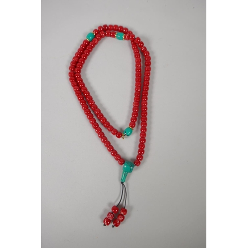 642 - A string of imitation coral mala beads, 82cm long