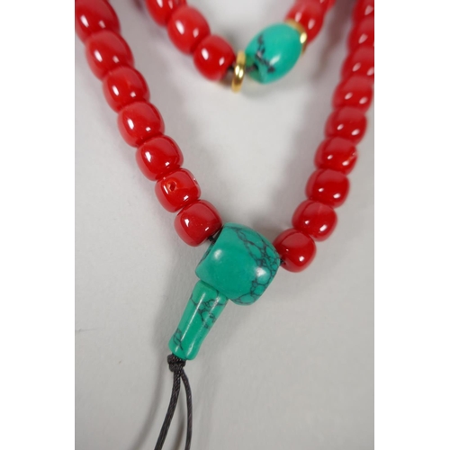 642 - A string of imitation coral mala beads, 82cm long