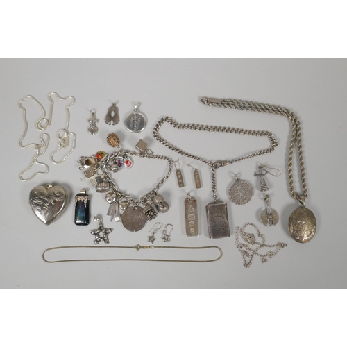 645 - A quantity of silver costume jewellery to include pendants, earrings, lockets, chains, charm bracele... 