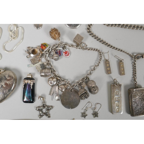 645 - A quantity of silver costume jewellery to include pendants, earrings, lockets, chains, charm bracele... 