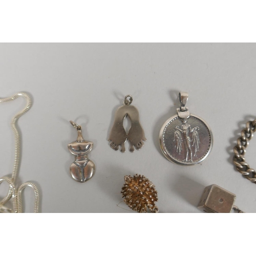 645 - A quantity of silver costume jewellery to include pendants, earrings, lockets, chains, charm bracele... 