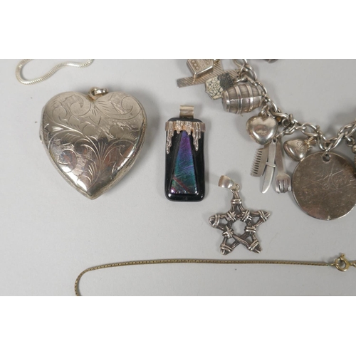 645 - A quantity of silver costume jewellery to include pendants, earrings, lockets, chains, charm bracele... 