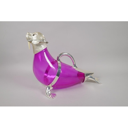 648 - A pink glass and silver plated claret jug in the form of a seal, 34cm long