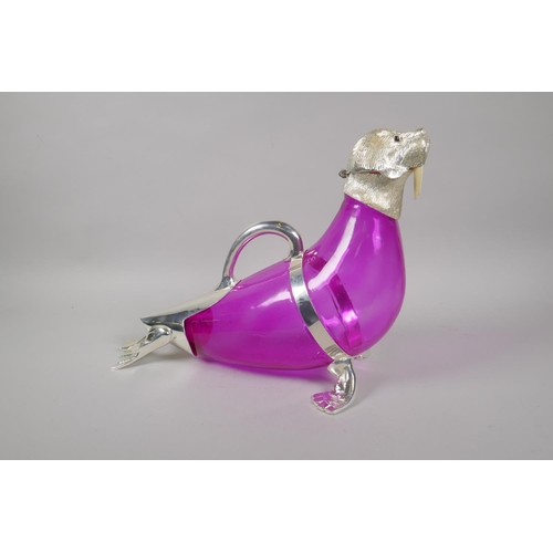 648 - A pink glass and silver plated claret jug in the form of a seal, 34cm long