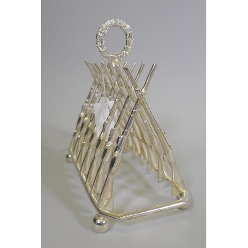 650 - A silver plated letter/toast rack in the form of leaning rifles, 20 x 9 x 18cm