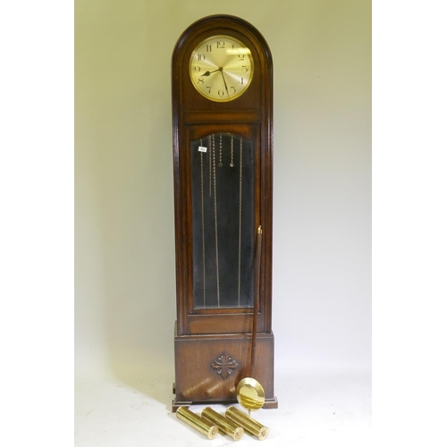 653 - A 1930s Art Deco style oak long case clock with dome top, silvered dial with Arabic numerals and eig... 