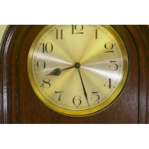 653 - A 1930s Art Deco style oak long case clock with dome top, silvered dial with Arabic numerals and eig... 