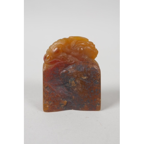 68 - A Chinese amber soapstone carving of a kylin, 6cm high