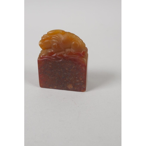 68 - A Chinese amber soapstone carving of a kylin, 6cm high