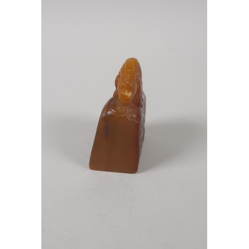 68 - A Chinese amber soapstone carving of a kylin, 6cm high