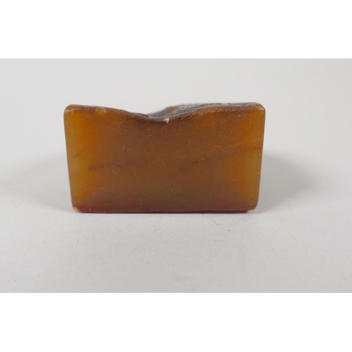 68 - A Chinese amber soapstone carving of a kylin, 6cm high