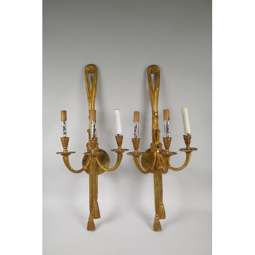 71 - A pair of French style of ormolu three branch wall sconces with rope and tassel decoration, 65cm