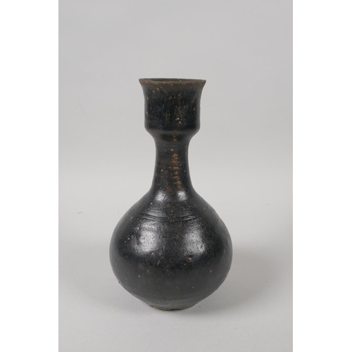 73 - A C19th Chinese treacle glazed pottery vase, 19cm high