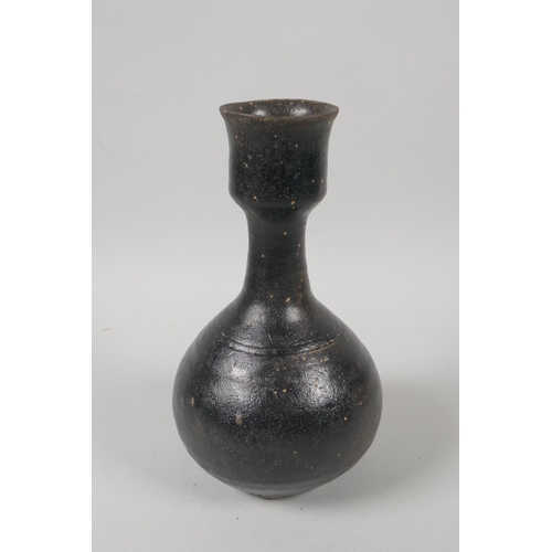 73 - A C19th Chinese treacle glazed pottery vase, 19cm high