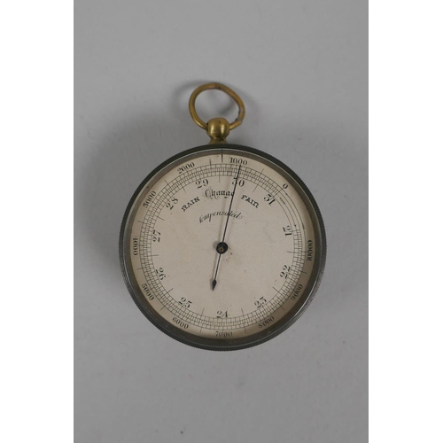 74 - An antique brass cased compensated pocket barometer in a leather case, 5cm diameter