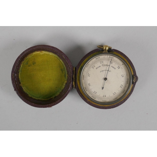 74 - An antique brass cased compensated pocket barometer in a leather case, 5cm diameter