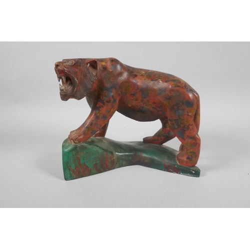 77 - An Indian carved and painted wood figure of a prowling tiger, 21cm long