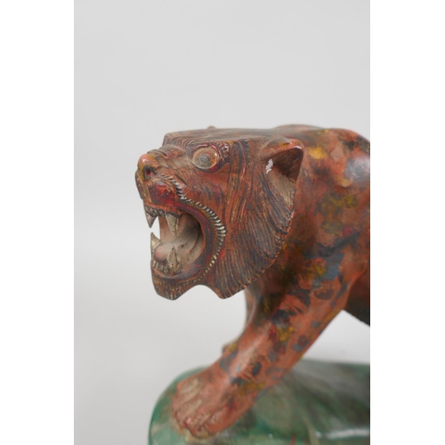 77 - An Indian carved and painted wood figure of a prowling tiger, 21cm long