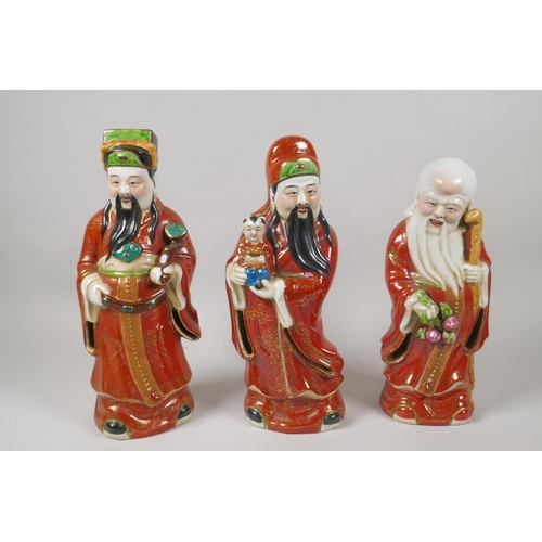 80 - Three Chinese polychrome porcelain figures depicting Fu, Lu and Shou, impressed mark to base, 29cm h... 