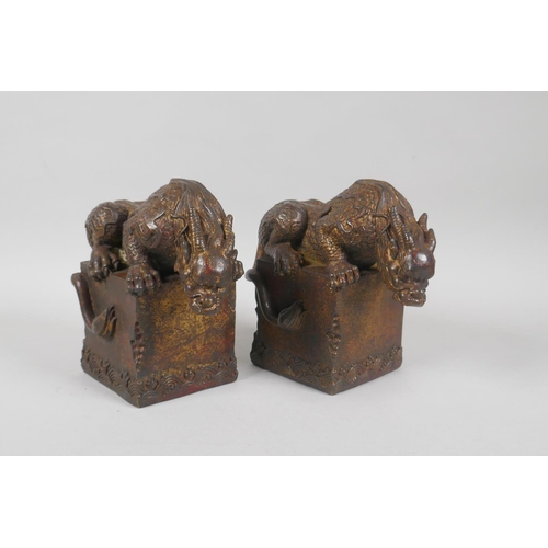 83 - A pair of Chinese filled gilt bronze desk weights in the form of kylin, 4 character mark to base, 15... 