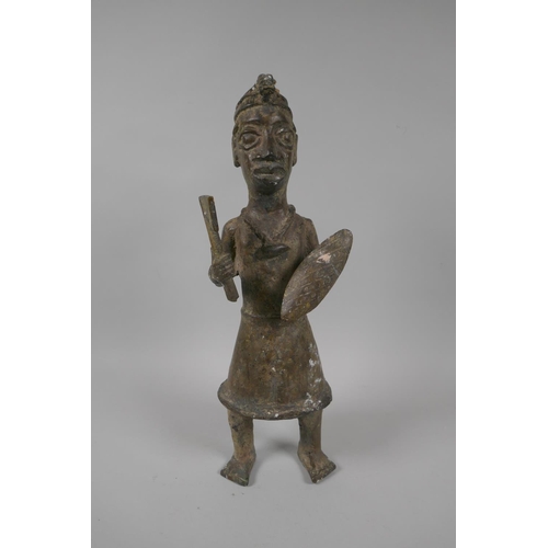 84 - An African Benin bronze figure of a warrior, 33cm high