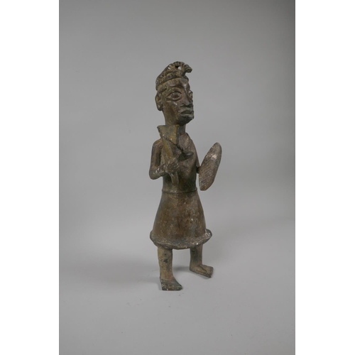 84 - An African Benin bronze figure of a warrior, 33cm high