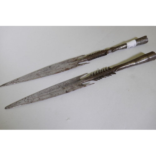 93 - Two African, Nigerian/Yoruba barbed metal spear heads, 30cm long