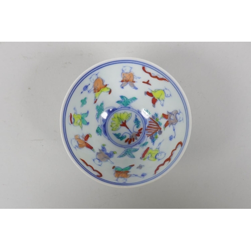 95 - A Chinese doucai porcelain tea bowl with raised floral decoration to the exterior, decorated with bo... 