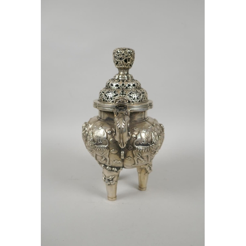 97 - A Chinese white metal censer and cover with kylin handles and tripod supports, 23cm high