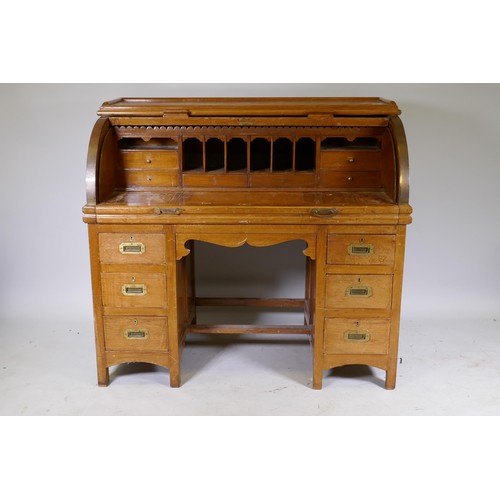 1018 - A C19th colonial teak cylinder top desk, the interior fitted with pigeon holes and six drawers, and ... 