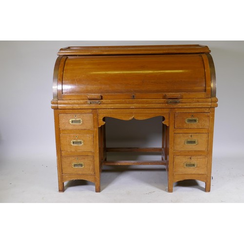 1018 - A C19th colonial teak cylinder top desk, the interior fitted with pigeon holes and six drawers, and ... 