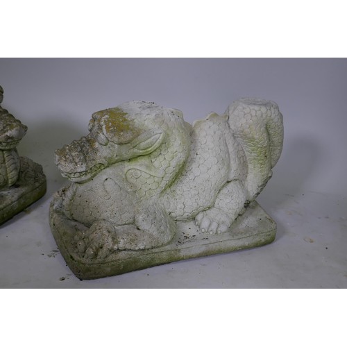 1081 - A pair of reconstituted stone dragons signed Helen Young, 54 x 34cm