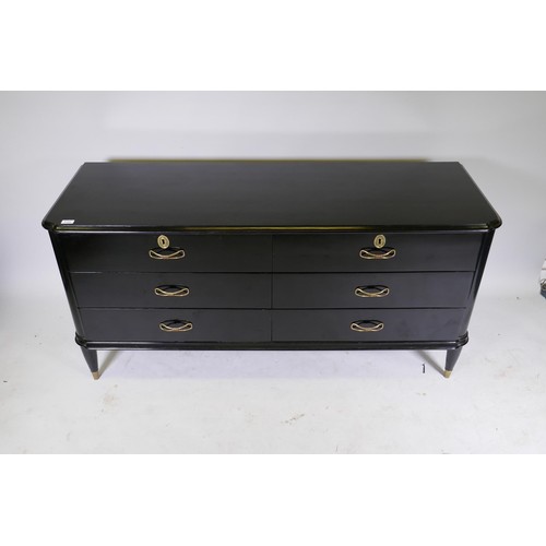 1122 - A mid century Continental black lacquer six drawer commode, the top with moulded edge over two fligh... 