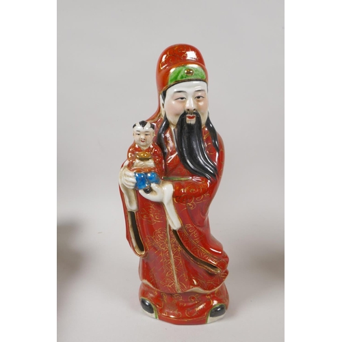 233 - Three Chinese polychrome porcelain figures depicting Fu, Lu and Shou, impressed mark to base, 29cm h... 